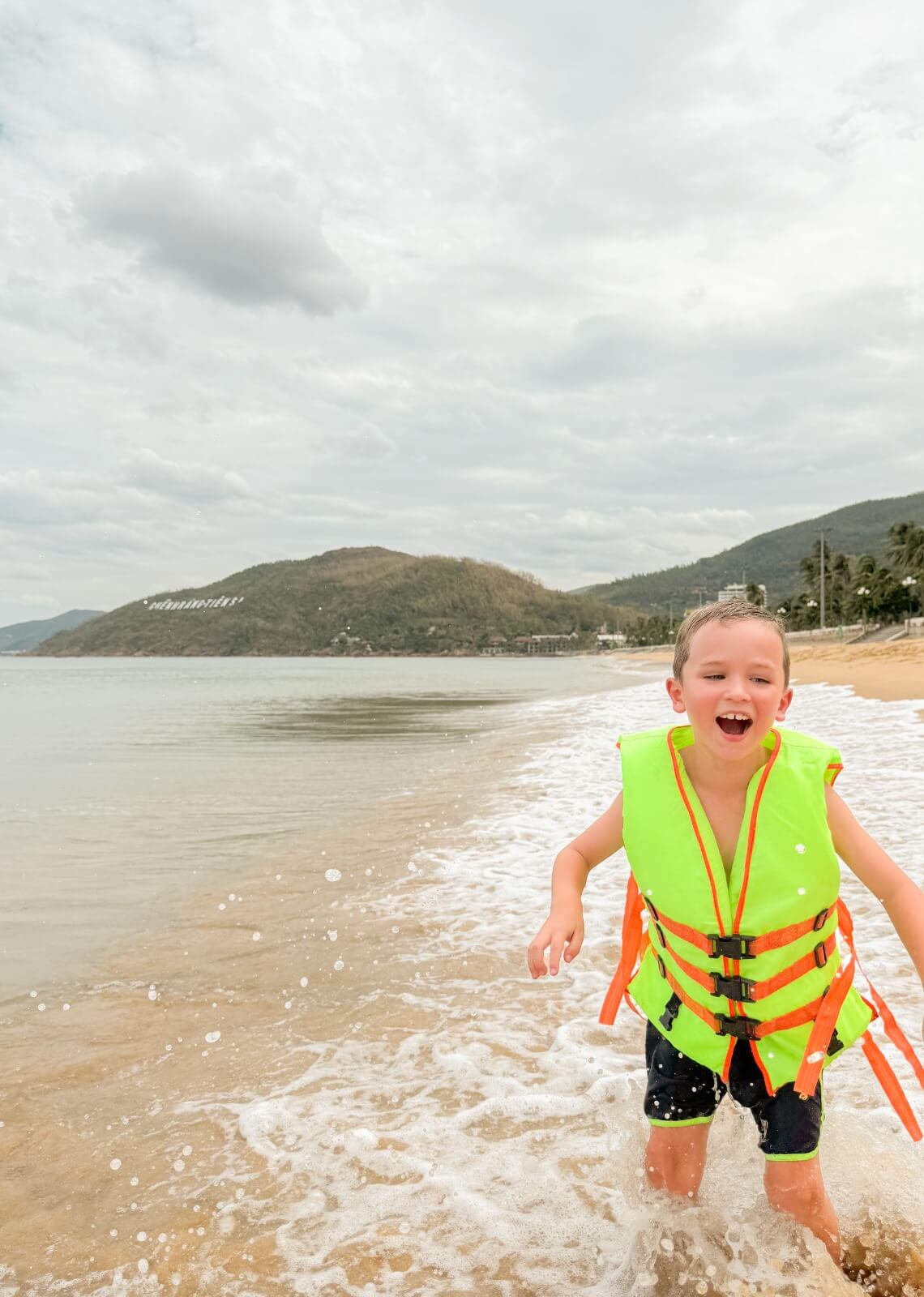 Otto juicht met zwemvest aan in de golven van Quy Nhon